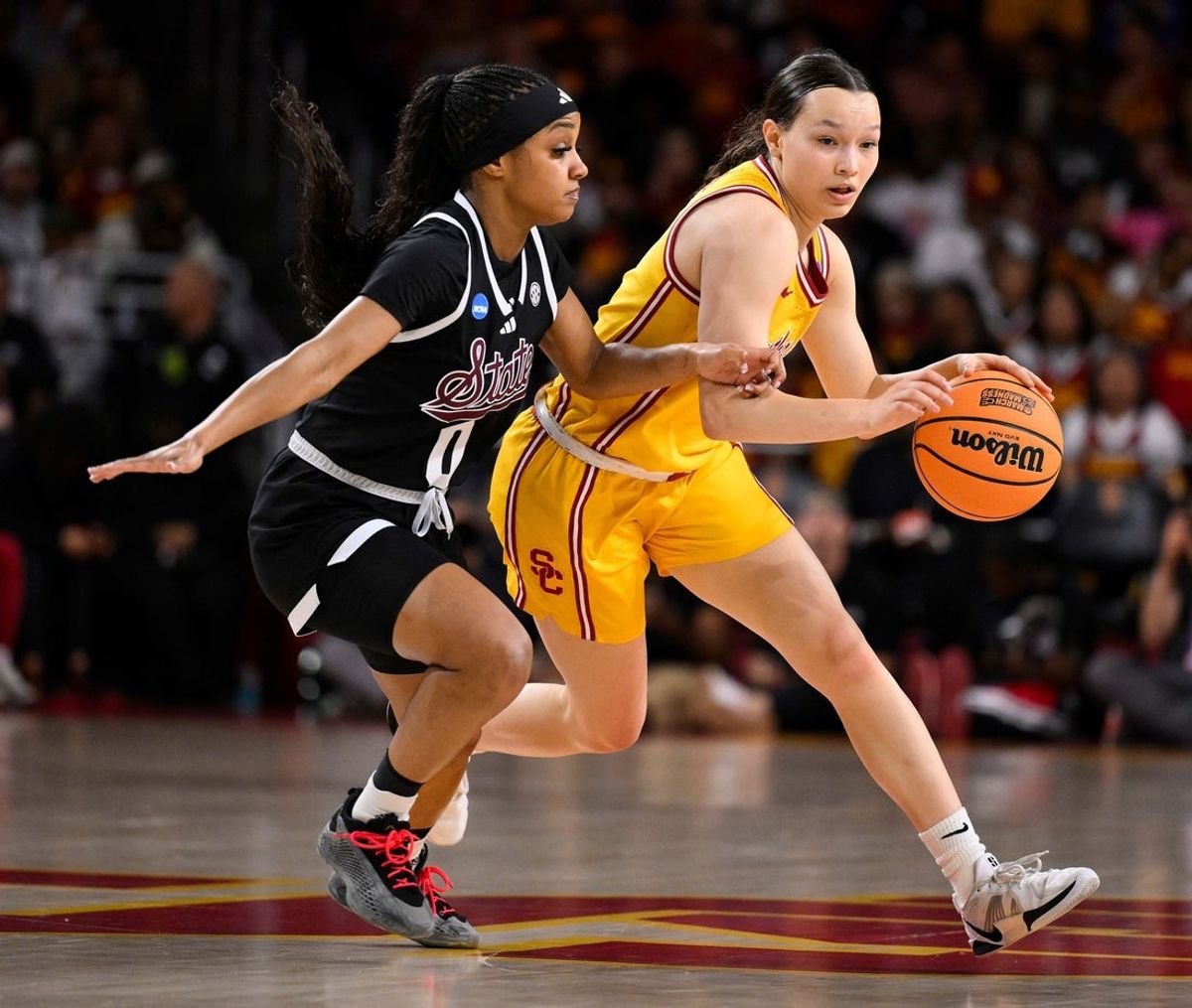 Mar 24, 2025; Los Angeles, California, USA; USC Trojans guard Kayleigh Heckel (9) dribbles the basketball past Mississippi State Bulldogs guard Denim DeShields (0) during an NCAA Tournament second round game at Galen Center. Mandatory Credit: Robert Hanashiro-Imagn Images