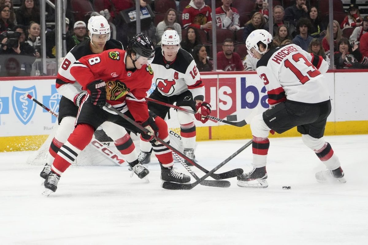 Mar 26, 2025; Chicago, Illinois, USA; Chicago Blackhawks center Ryan Donato (8) and New Jersey Devils center Nico Hischier (13) go for the puck during the first period at United Center. Mandatory Credit: David Banks-Imagn Images