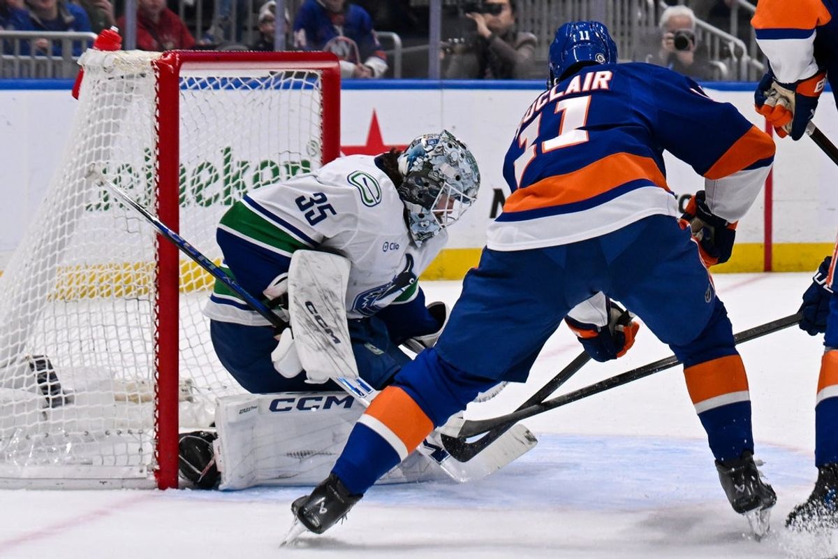 Mar 26, 2025; Elmont, New York, USA;  Vancouver Canucks goaltender Thatcher Demko (35) makes a save on New York Islanders left wing Anthony Duclair (11) during the second period at UBS Arena. Mandatory Credit: Dennis Schneidler-Imagn Images