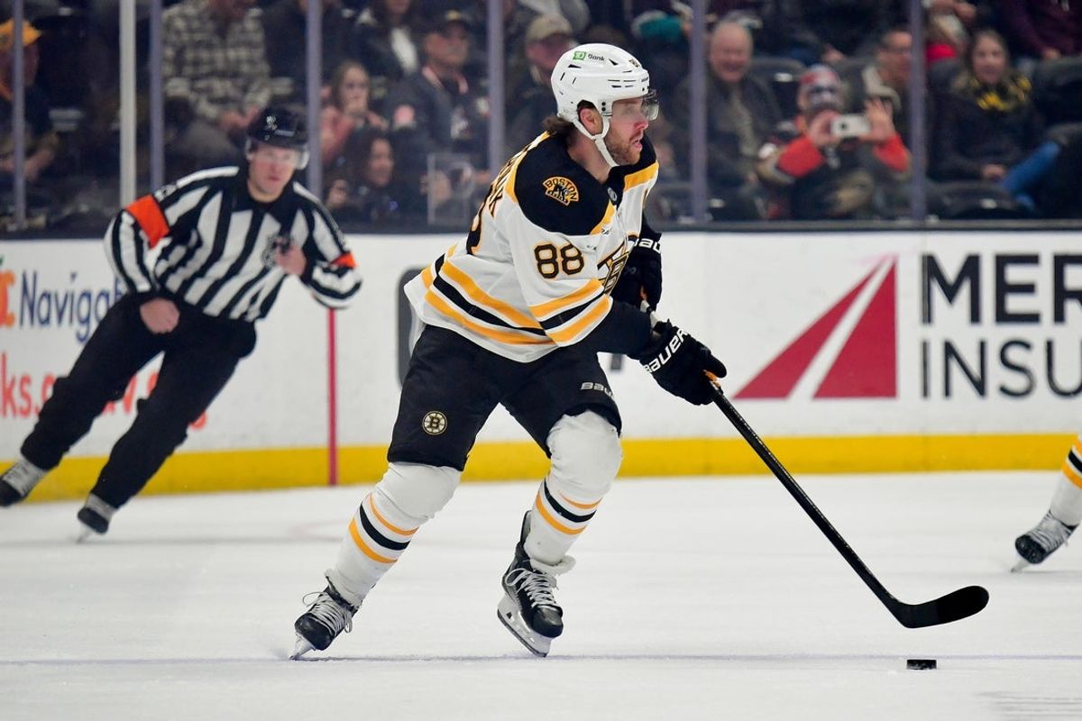 Mar 26, 2025; Anaheim, California, USA; Boston Bruins right wing David Pastrnak (88) moves the puck against the Anaheim Ducks during the first period at Honda Center. Mandatory Credit: Gary A. Vasquez-Imagn Images