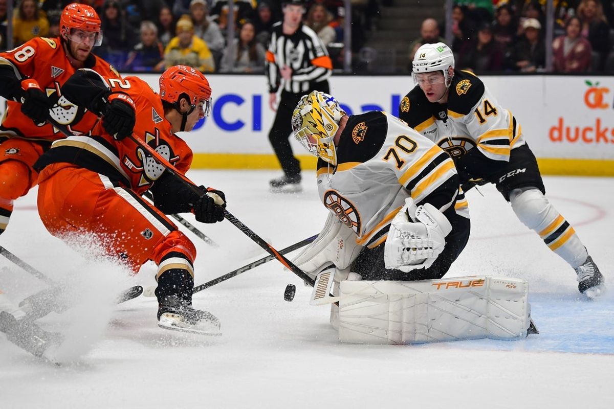 Mar 26, 2025; Anaheim, California, USA; Anaheim Ducks center Nikita Nesterenko (62) shoots on goal against Boston Bruins goaltender Joonas Korpisalo (70) during the second period at Honda Center. Mandatory Credit: Gary A. Vasquez-Imagn Images
