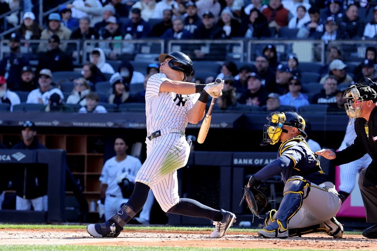 Mar 27, 2025; Bronx, New York, USA; New York Yankees shortstop Anthony Volpe (11) follows through on a solo home run against the Milwaukee Brewers during the second inning at Yankee Stadium. Mandatory Credit: Brad Penner-Imagn Images