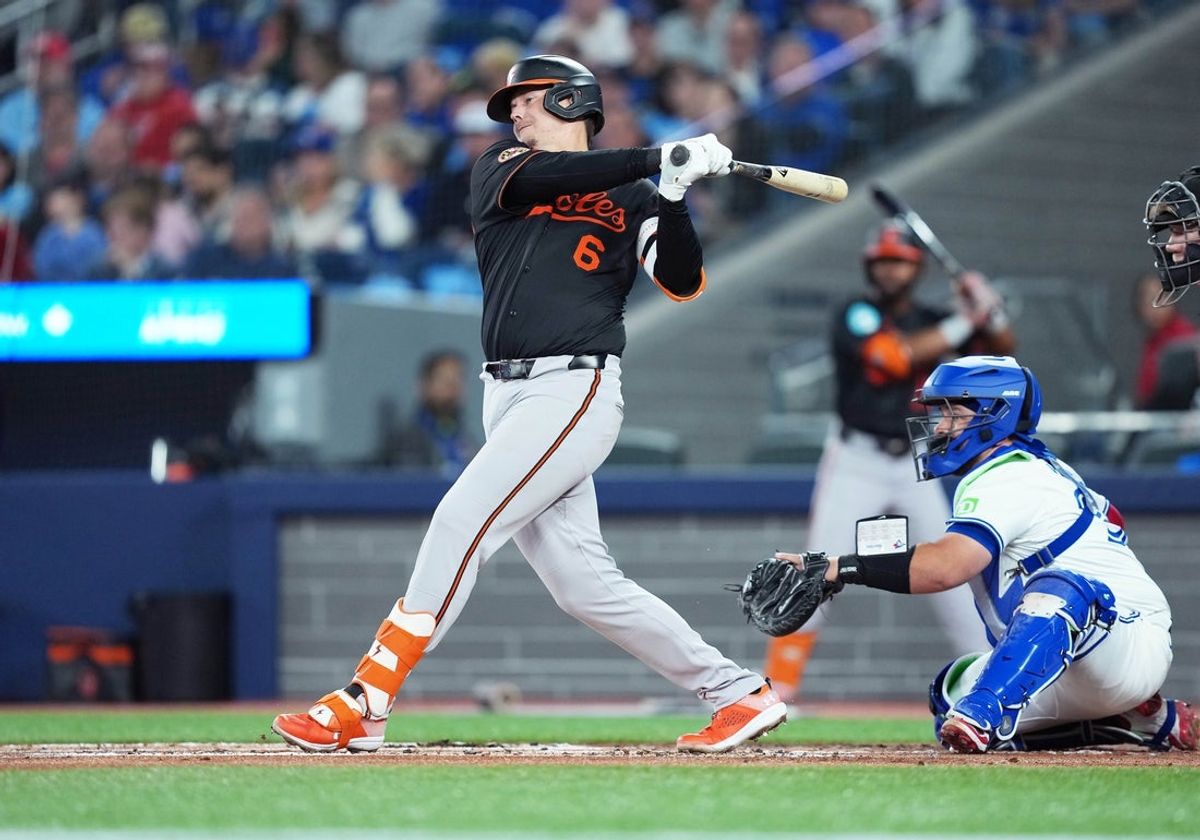 Mar 27, 2025; Toronto, Ontario, CAN; Baltimore Orioles first base Ryan Mountcastle (6) hits a double against the Toronto Blue Jays during the second inning at Rogers Centre. Mandatory Credit: Nick Turchiaro-Imagn Images