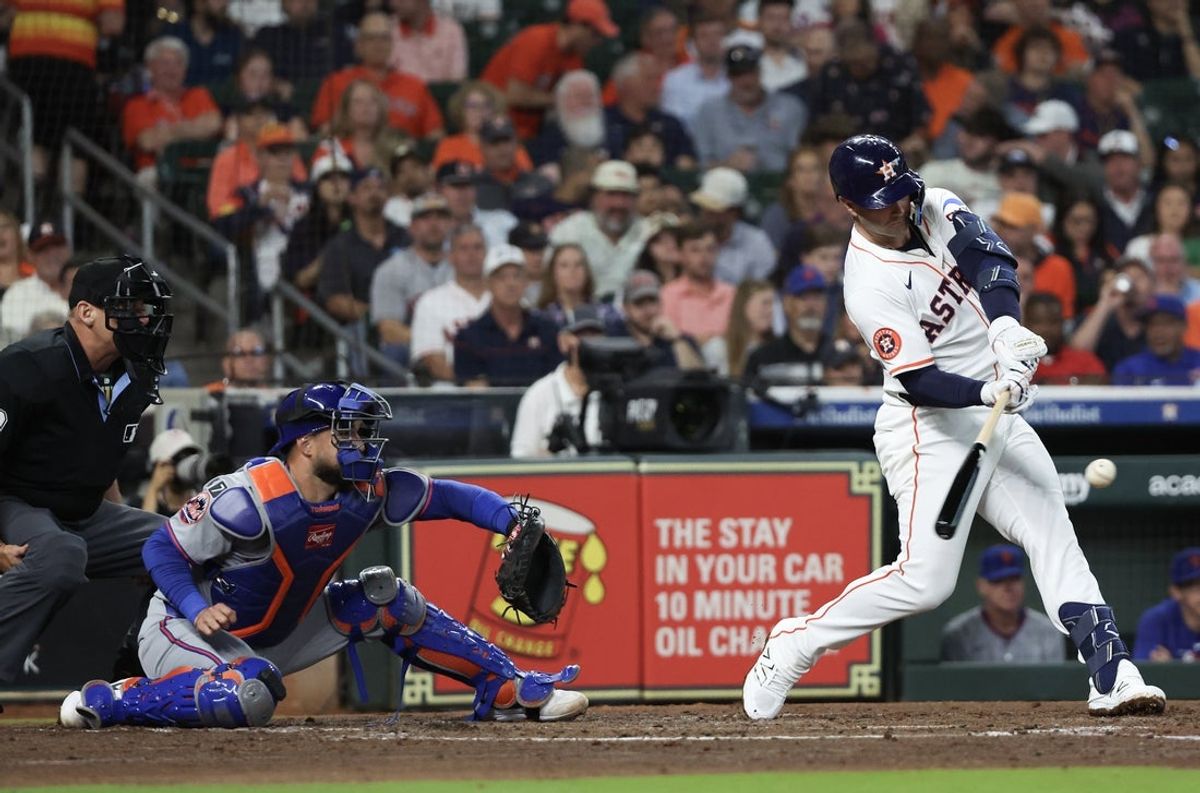 Mar 27, 2025; Houston, Texas, USA; Houston Astros first base Christian Walker (8) hits a RBI single against the New York Mets in the third inning at Daikin Park. Mandatory Credit: Thomas Shea-Imagn Images