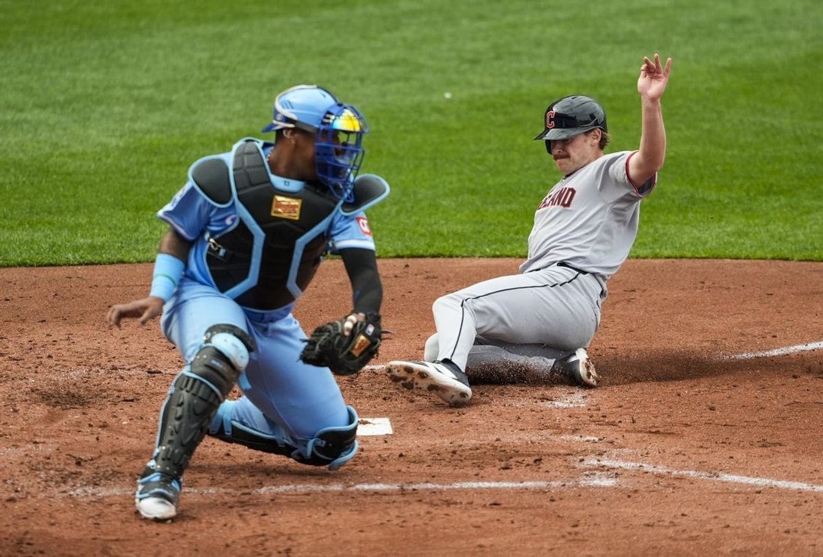 Mar 27, 2025; Kansas City, Missouri, USA; Cleveland Guardians designated hitter Kyle Manzardo (9) scores a run against Kansas City Royals catcher Salvador Perez (13) during the fourth inning at Kauffman Stadium. Mandatory Credit: Jay Biggerstaff-Imagn Images