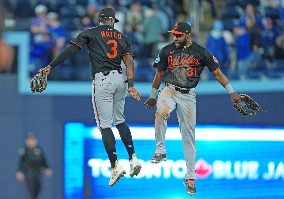 Mar 27, 2025; Toronto, Ontario, CAN; Baltimore Orioles centre fielder Cedric Mullins (31) celebrates the win with shortstop Jorge Mateo (3) against the Toronto Blue Jays at the end of the ninth inning at Rogers Centre. Mandatory Credit: Nick Turchiaro-Imagn Images