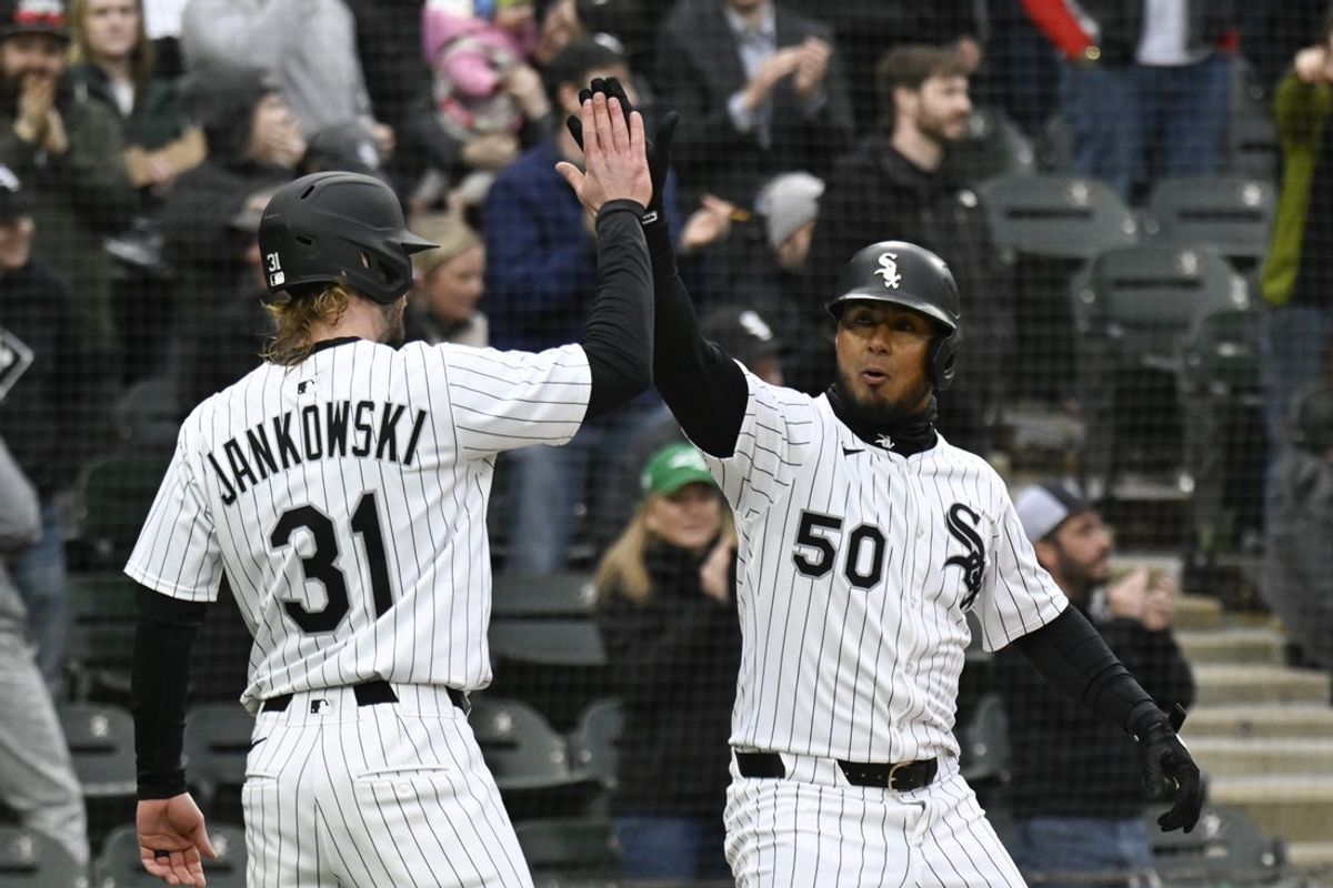 Mar 27, 2025; Chicago, Illinois, USA;  Chicago White Sox third base Lenyn Sosa (50) high fives Chicago White Sox outfielder Travis Jankowski (19) after he hits a two run home run against the Los Angeles Angels during the eighth inning at Guaranteed Rate Field. Mandatory Credit: Matt Marton-Imagn Images