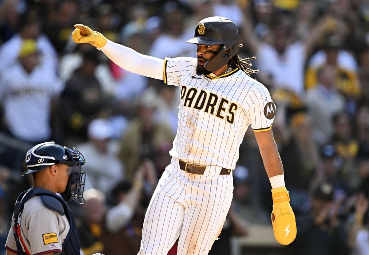 Mar 27, 2025; San Diego, California, USA; San Diego Padres right fielder Fernando Tatis Jr. (23) celebrates as he scores during the seventh inning against the Atlanta Braves at Petco Park. Mandatory Credit: Denis Poroy-Imagn Images