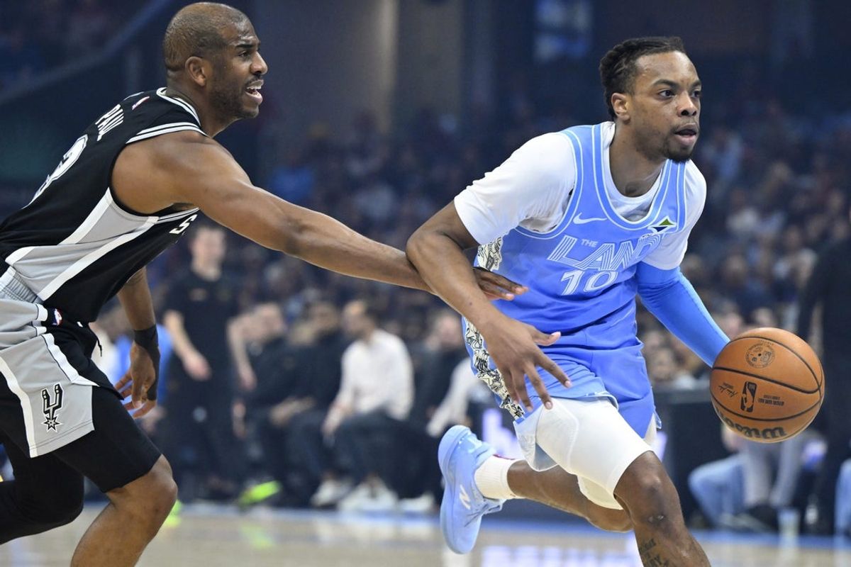 Mar 27, 2025; Cleveland, Ohio, USA; Cleveland Cavaliers guard Darius Garland (10) dribbles against San Antonio Spurs guard Chris Paul (3) in the first quarter at Rocket Arena. Mandatory Credit: David Richard-Imagn Images