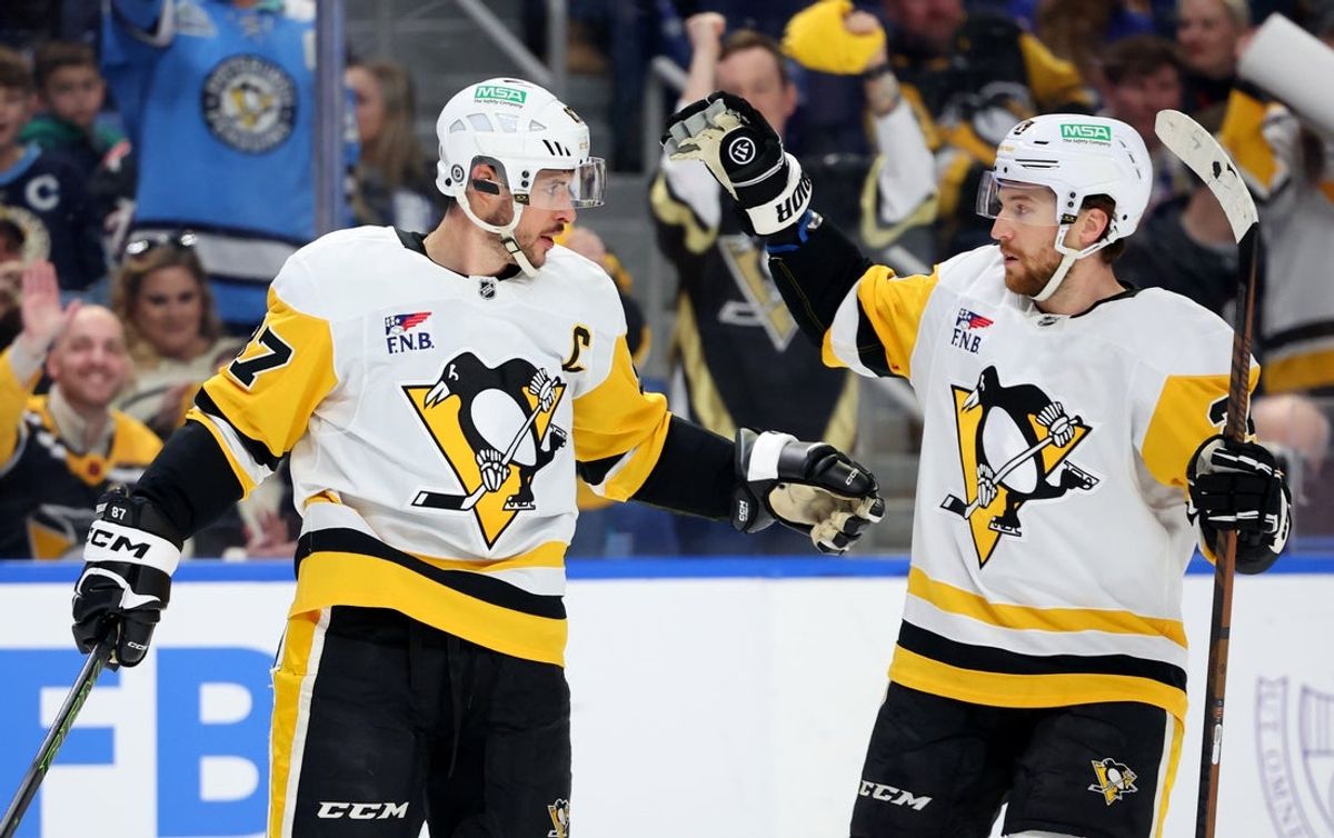 Mar 27, 2025; Buffalo, New York, USA;  Pittsburgh Penguins center Sidney Crosby (87) celebrates his goal with defenseman Matt Grzelcyk (24) during the first period against the Buffalo Sabres at KeyBank Center. Mandatory Credit: Timothy T. Ludwig-Imagn Images