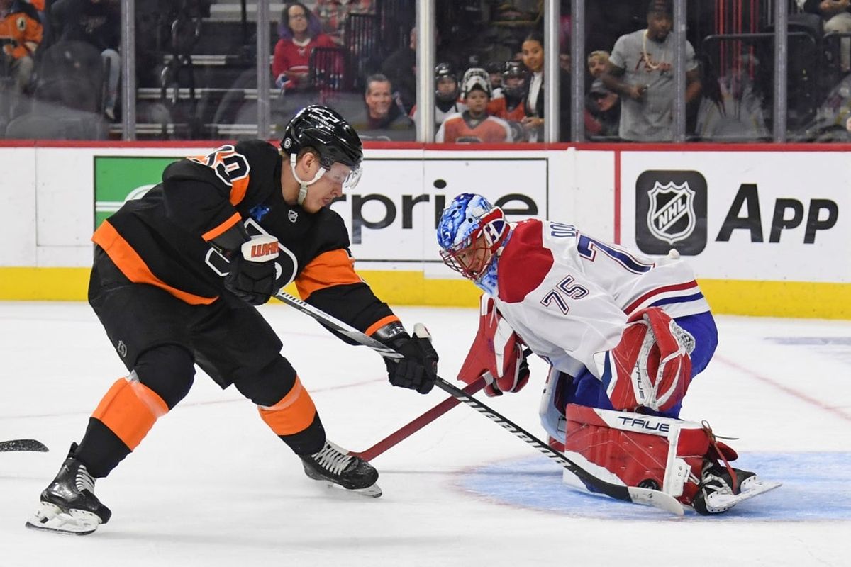 Mar 27, 2025; Philadelphia, Pennsylvania, USA; Montreal Canadiens goaltender Jakub Dobes (75) makes a save against Philadelphia Flyers right wing Matvei Michkov (39) during the first period at Wells Fargo Center. Mandatory Credit: Eric Hartline-Imagn Images