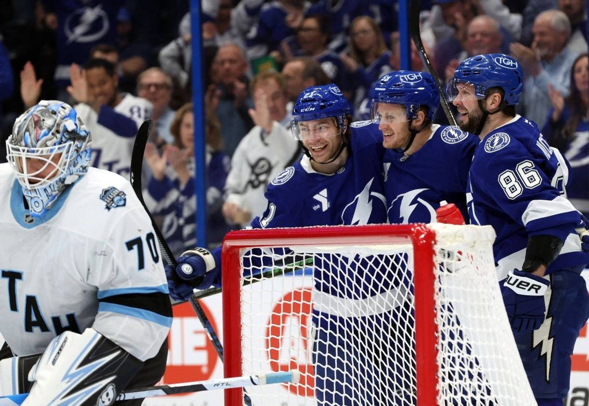 Mar 27, 2025; Tampa, Florida, USA; Tampa Bay Lightning center Jake Guentzel (59) is congratulated by right wing Nikita Kucherov (86) and center Brayden Point (21)  after he scored on Utah Hockey Club goaltender Karel Vejmelka (70) during the first period at Amalie Arena. Mandatory Credit: Kim Klement Neitzel-Imagn Images