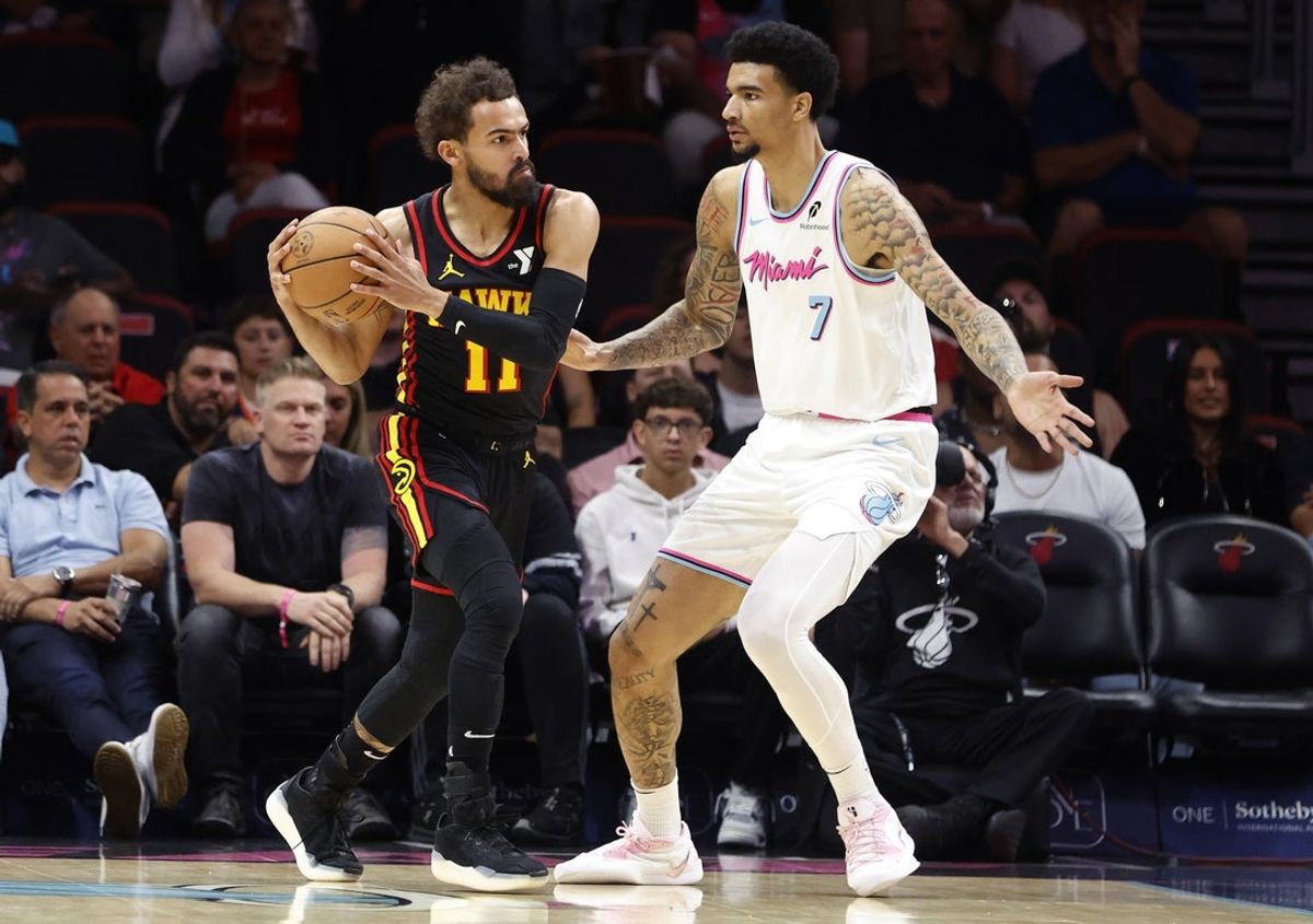 Mar 27, 2025; Miami, Florida, USA;  Miami Heat center Kel'el Ware (7) defends Atlanta Hawks guard Trae Young (11) during the fist half at Kaseya Center. Mandatory Credit: Rhona Wise-Imagn Images
