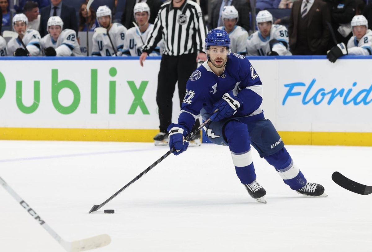 Mar 27, 2025; Tampa, Florida, USA; Tampa Bay Lightning right wing Oliver Bjorkstrand (22) skates and scores a goal against the Utah Hockey Club during the third period at Amalie Arena. Mandatory Credit: Kim Klement Neitzel-Imagn Images