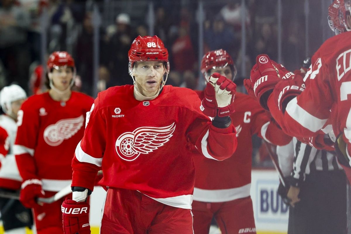 Mar 27, 2025; Detroit, Michigan, USA;  Detroit Red Wings right wing Patrick Kane (88) is congratulated by teammates after scoring in the third period against the Ottawa Senators at Little Caesars Arena. Mandatory Credit: Rick Osentoski-Imagn Images