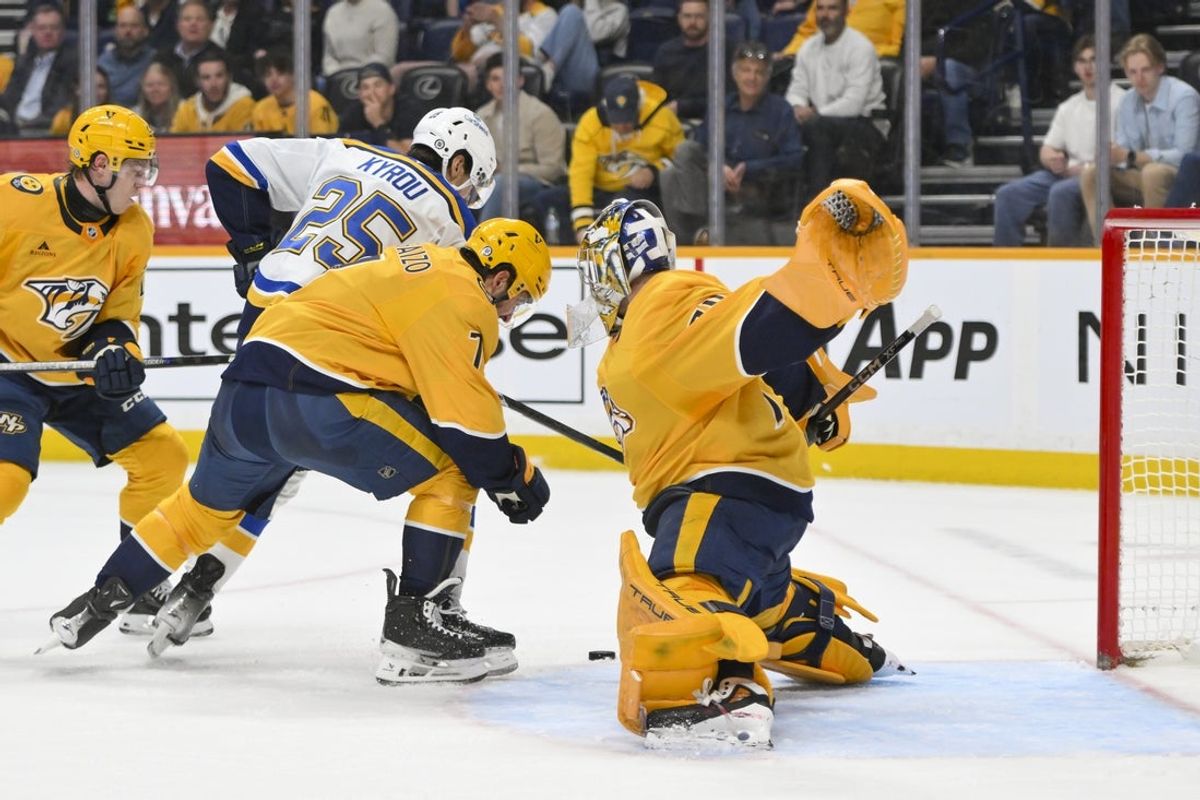 Mar 27, 2025; Nashville, Tennessee, USA;  Nashville Predators goaltender Juuse Saros (74) blocks the shot of St. Louis Blues center Jordan Kyrou (25) during the second period at Bridgestone Arena. Mandatory Credit: Steve Roberts-Imagn Images