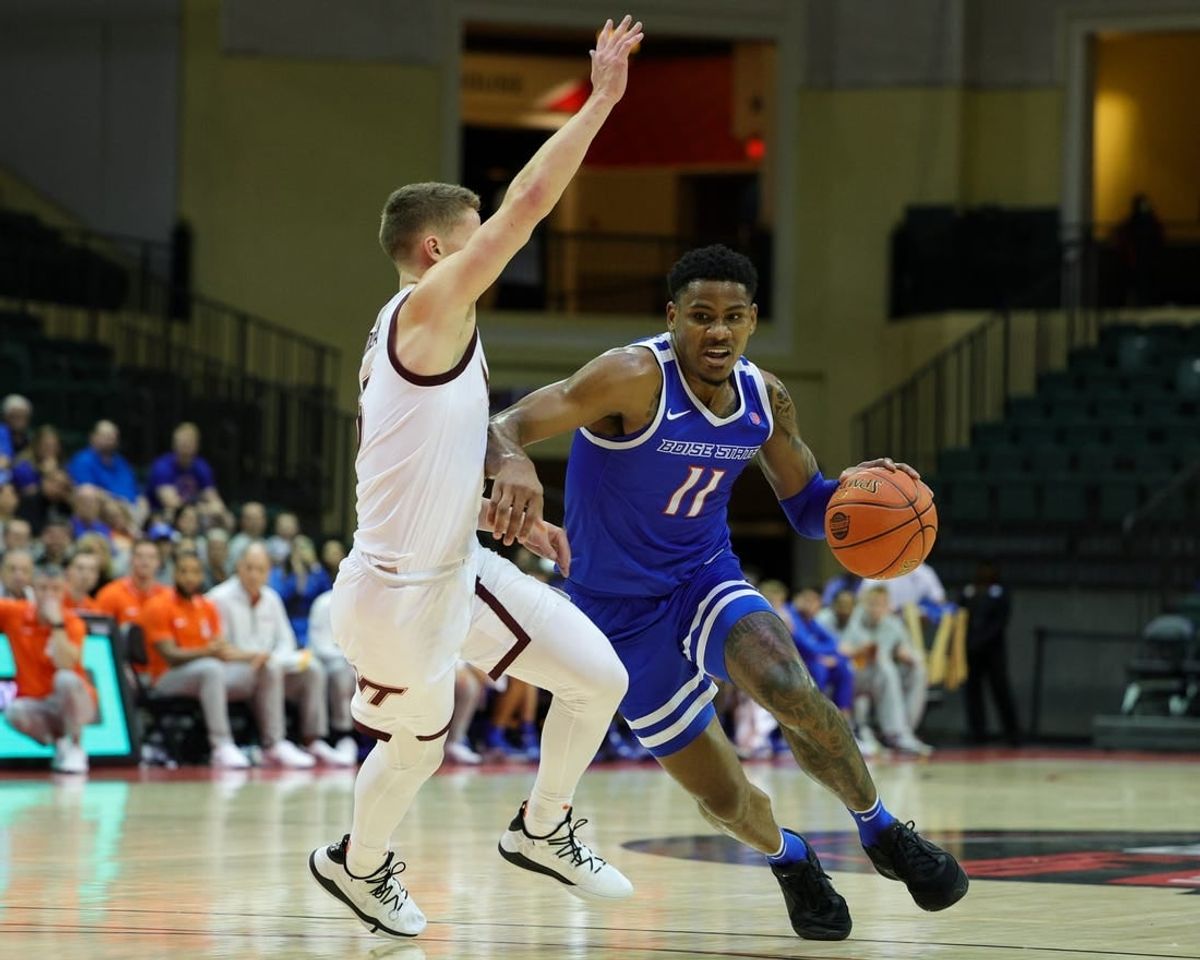 Nov 23, 2023; Kissimmee, FL, USA;  Boise State Broncos guard Chibuzo Agbo (11) drives past Virginia Tech Hokies guard Sean Pedulla (3) in the first half during the ESPN Events Invitational at State Farm Field House.