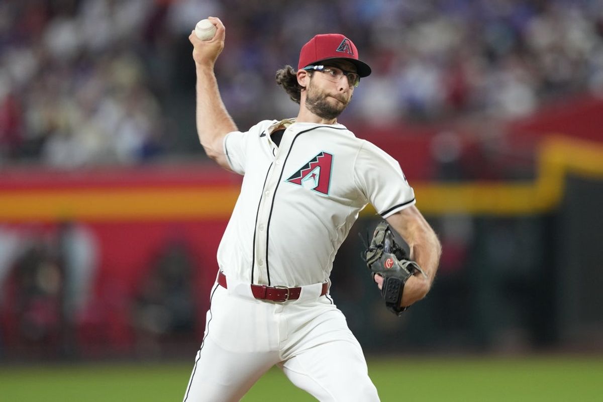 Mar 27, 2025; Phoenix, Arizona, USA; Arizona Diamondbacks pitcher Zac Gallen (23) pitches against the Chicago Cubs during the first inning at Chase Field. Mandatory Credit: Joe Camporeale-Imagn Images