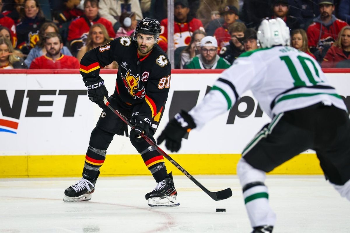 Mar 27, 2025; Calgary, Alberta, CAN; Calgary Flames center Nazem Kadri (91) controls the puck against the Dallas Stars during the second period at Scotiabank Saddledome. Mandatory Credit: Sergei Belski-Imagn Images