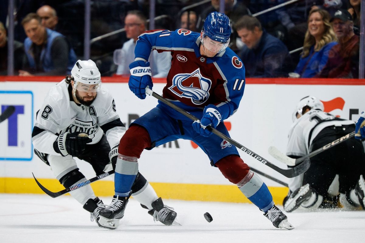 Mar 27, 2025; Denver, Colorado, USA; Colorado Avalanche center Brock Nelson (11) controls the puck ahead of Los Angeles Kings defenseman Drew Doughty (8) in the first period at Ball Arena. Mandatory Credit: Isaiah J. Downing-Imagn Images