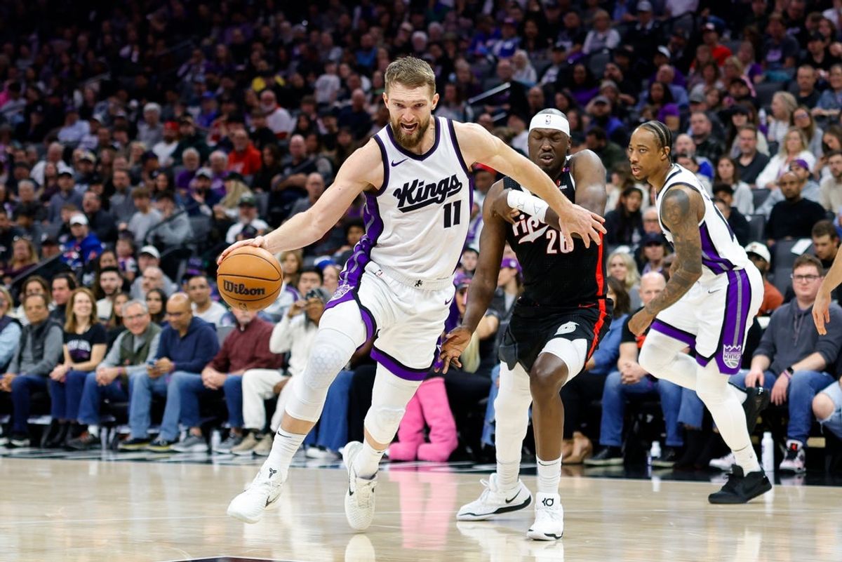Mar 27, 2025; Sacramento, California, USA; Sacramento Kings forward Domantas Sabonis (11) dribbles past Portland Trail Blazers center Duop Reath (26) during the second quarter at Golden 1 Center. Mandatory Credit: Sergio Estrada-Imagn Images