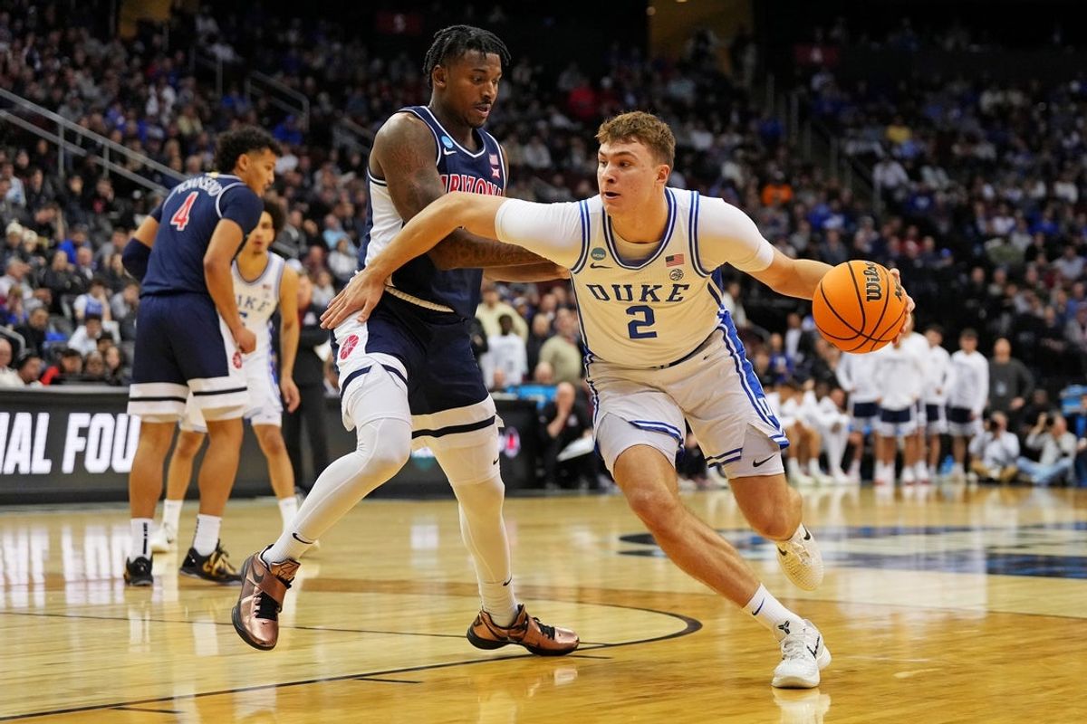 Mar 27, 2025; Newark, NJ, USA; Duke Blue Devils forward Cooper Flagg (2) drives to the basket against Arizona Wildcats guard Jaden Bradley (0) during the second half during an East Regional semifinal of the 2025 NCAA tournament at Prudential Center. Mandatory Credit: Robert Deutsch-Imagn Images