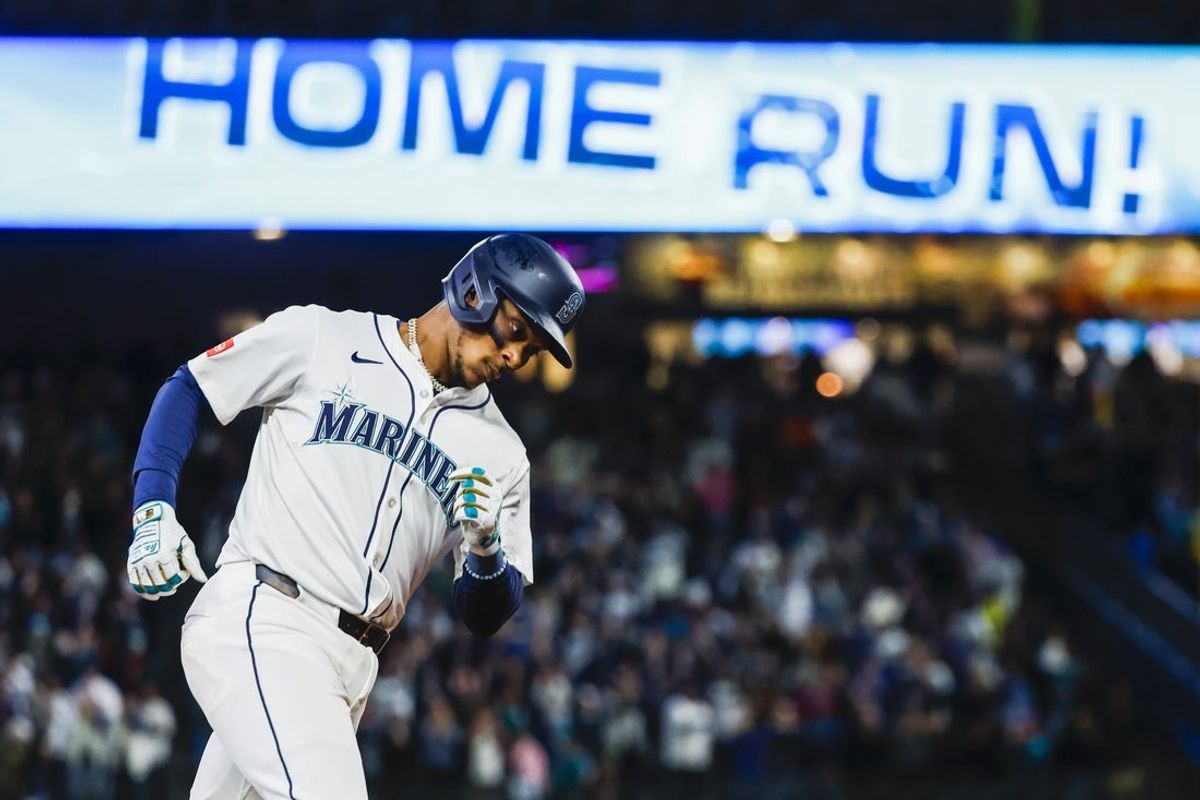 Mar 27, 2025; Seattle, Washington, USA; Seattle Mariners third baseman Jorge Polanco (7) celebrates while running the bases after hitting a two-run home run against the Athletics during the eighth inning at T-Mobile Park. Mandatory Credit: Joe Nicholson-Imagn Images
