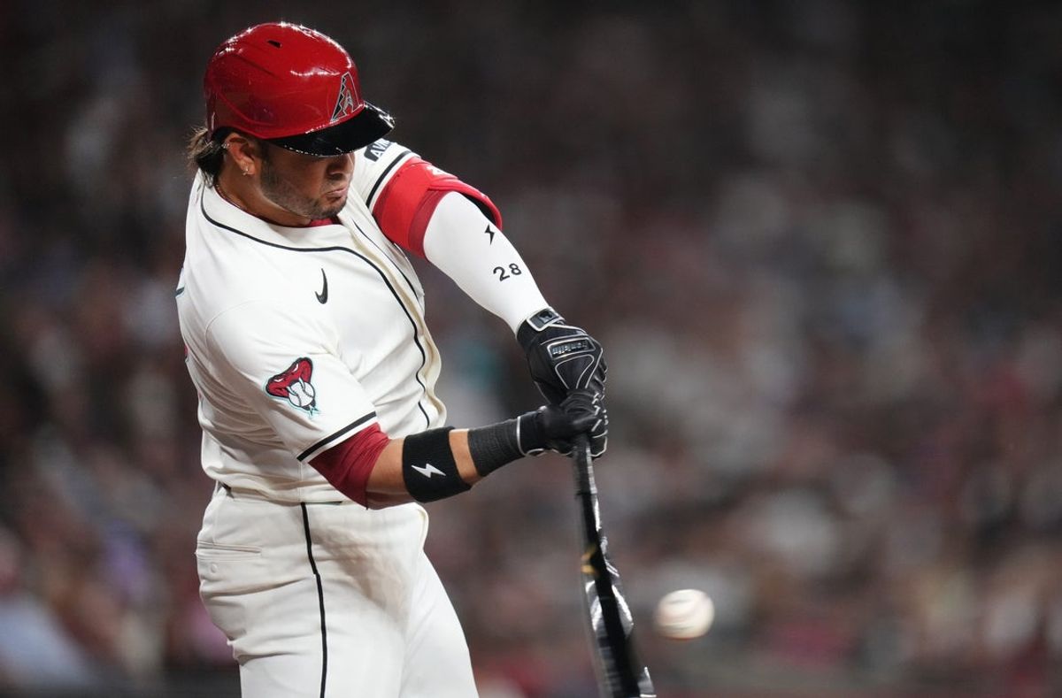 Arizona Diamondbacks Eugenio Suarez (28) hits a single during their Opening Day game against the Chicago Cubs at Chase Field in Phoenix on March 27, 2025.