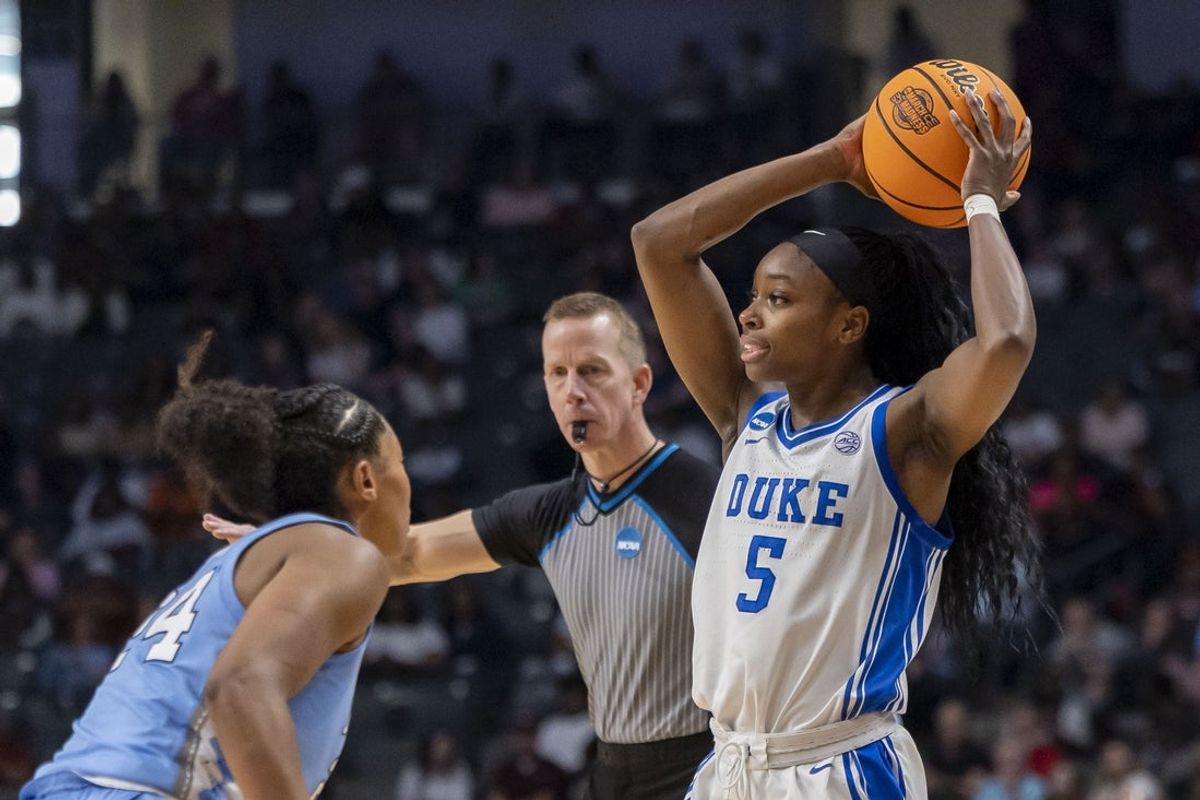 Mar 28, 2025; Birmingham, AL, USA; Duke Blue Devils guard Oluchi Okananwa (5) looks to pass over North Carolina Tar Heels guard Indya Nivar (24) during the Sweet 16 NCAA Tournament basketball game at Legacy Arena. Mandatory Credit: Vasha Hunt-Imagn Images