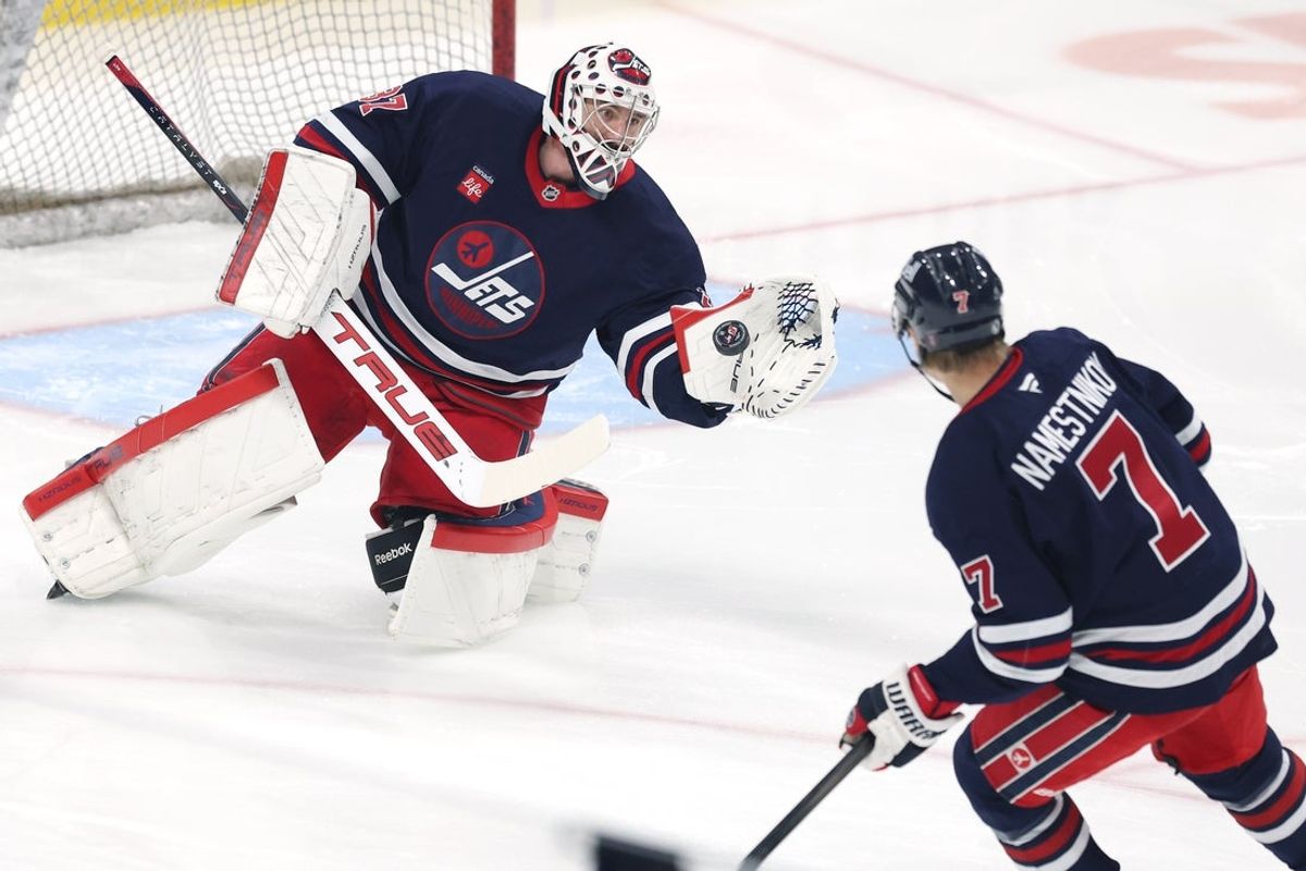 Winnipeg Jets center Vladislav Namestnikov (7) takes a shot on Winnipeg Jets goaltender Connor Hellebuyck (37) before a game against the New Jersey Devils at Canada Life Centre. Mandatory Credit: James Carey Lauder-Imagn Images
