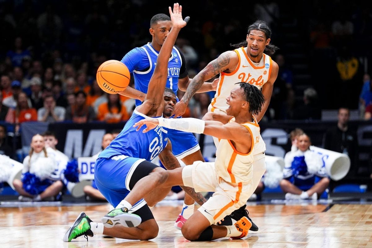 Tennessee guard Jordan Gainey (11) passes the ball to a teammate from the ground while defended by Kentucky guard Otega Oweh (0) during a NCAA Tournament Sweet 16 game between Tennessee and Kentucky at Lucas Oil Stadium in Indianapolis, Ind., on Thursday, March 27, 2024.