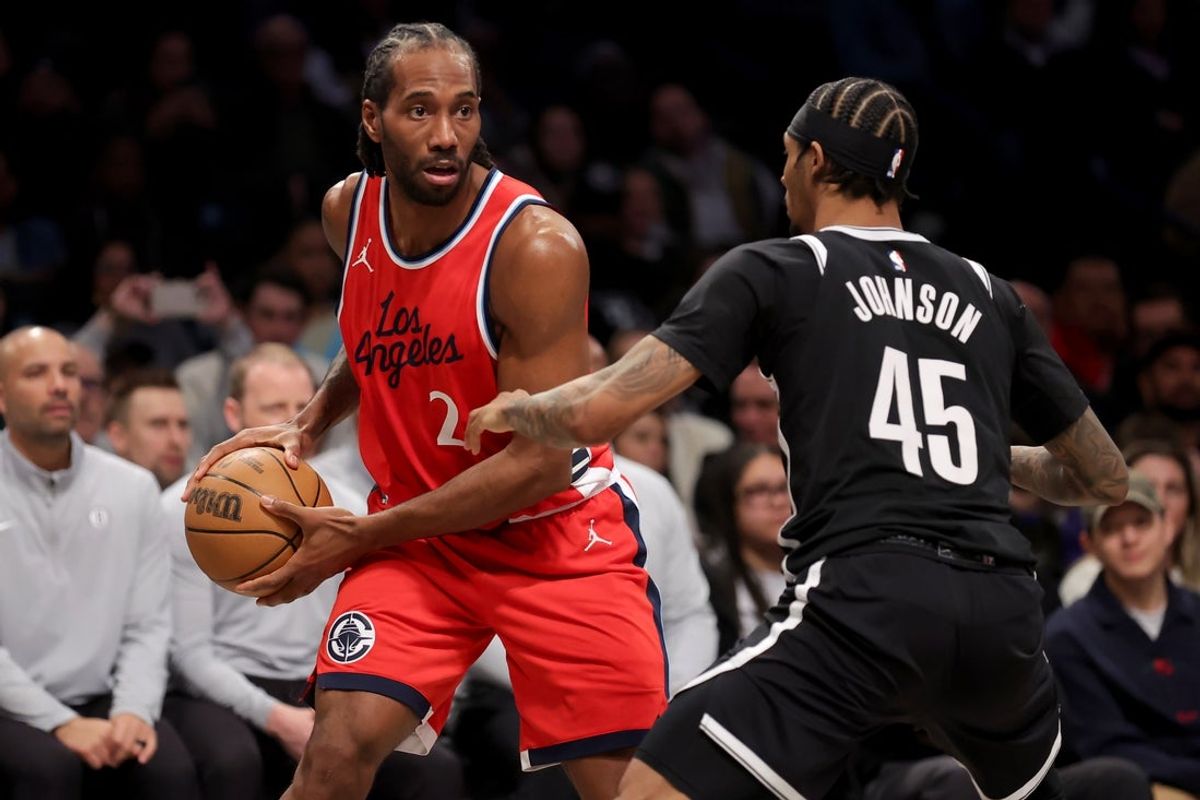 Mar 28, 2025; Brooklyn, New York, USA; Los Angeles Clippers forward Kawhi Leonard (2) controls the ball against Brooklyn Nets guard Keon Johnson (45) during the second quarter at Barclays Center. Mandatory Credit: Brad Penner-Imagn Images