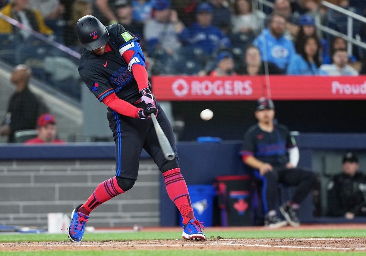 Mar 28, 2025; Toronto, Ontario, CAN; Toronto Blue Jays right fielder George Springer (4) hits a single against the Baltimore Orioles during the fourth inning at Rogers Centre. Mandatory Credit: Nick Turchiaro-Imagn Images