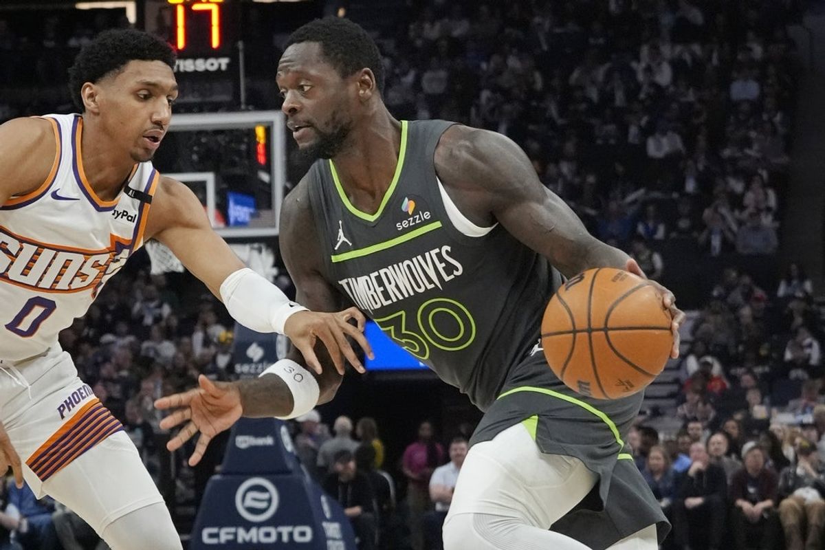 Mar 28, 2025; Minneapolis, Minnesota, USA; Minnesota Timberwolves forward Julius Randle (30) works past Phoenix Suns guard Ryan Dunn (0) in the first quarter at Target Center. Mandatory Credit: Bruce Kluckhohn-Imagn Images