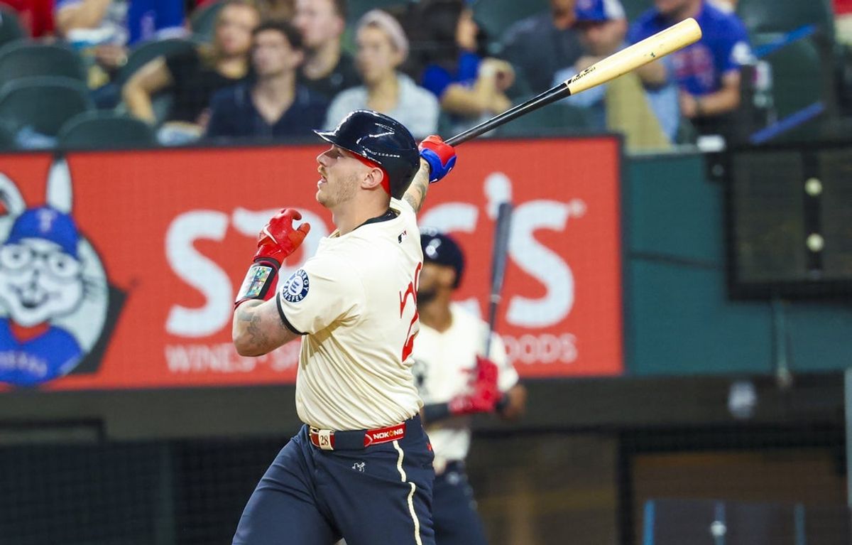 Mar 28, 2025; Arlington, Texas, USA;  Texas Rangers catcher Jonah Heim (28) hits a home run during the third inning against the Boston Red Sox at Globe Life Field. Mandatory Credit: Kevin Jairaj-Imagn Images