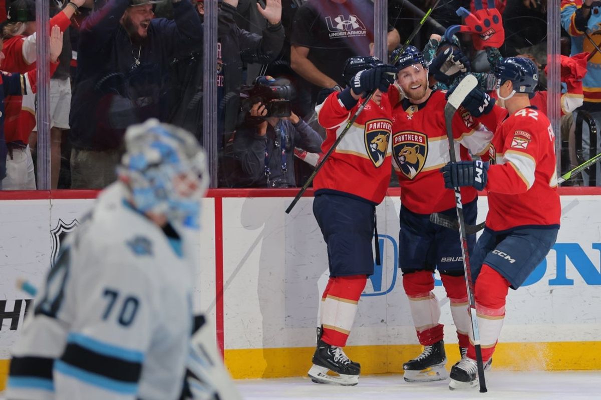Mar 28, 2025; Sunrise, Florida, USA; Florida Panthers center Sam Bennett (9) celebrates with teammates after scoring the game-winning goal against the Utah Hockey Club during overtime at Amerant Bank Arena. Mandatory Credit: Sam Navarro-Imagn Images