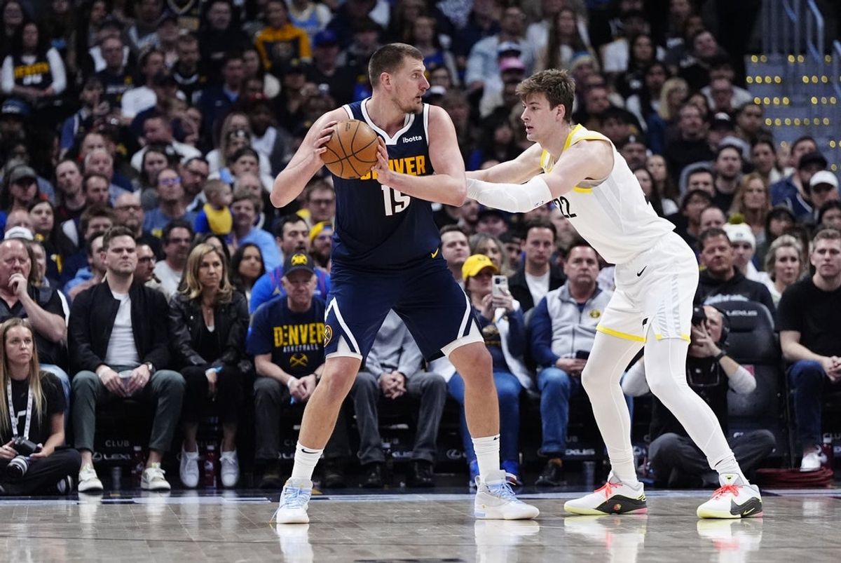 Mar 28, 2025; Denver, Colorado, USA; Utah Jazz forward Kyle Filipowski (22) defends on Denver Nuggets center Nikola Jokic (15) in the second quarter at Ball Arena. Mandatory Credit: Ron Chenoy-Imagn Images