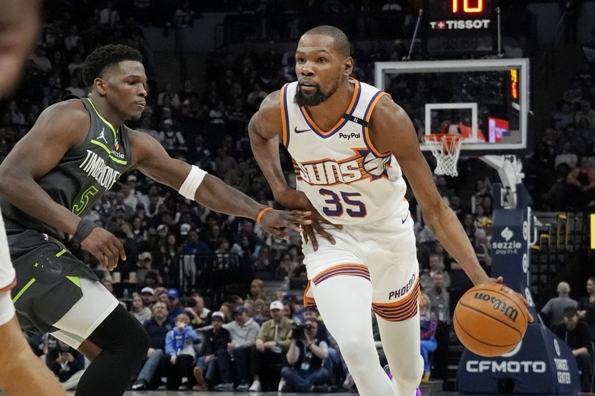 Mar 28, 2025; Minneapolis, Minnesota, USA; Phoenix Suns forward Kevin Durant (35) brings the ball up as Minnesota Timberwolves guard Anthony Edwards (5) defends him in the fourth quarter at Target Center. Mandatory Credit: Bruce Kluckhohn-Imagn Images