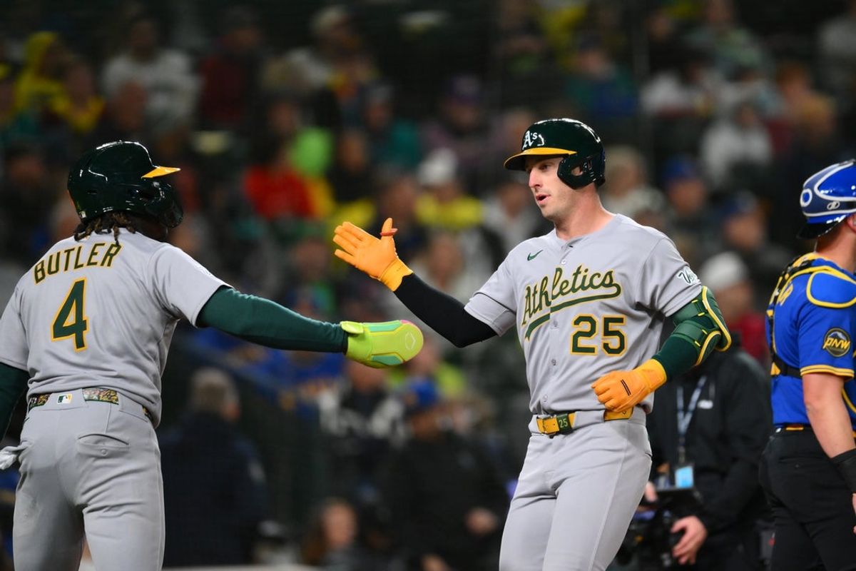 Mar 28, 2025; Seattle, Washington, USA; Athletics right fielder Lawrence Butler (4) and Athletics designated hitter Brent Rooker (25) celebrate after Rooker hit a 2-run home run against the Seattle Mariners during the fifth inning at T-Mobile Park. Mandatory Credit: Steven Bisig-Imagn Images