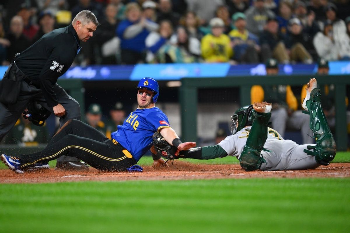Mar 28, 2025; Seattle, Washington, USA; Athletics catcher Shea Langeliers (23) tags Seattle Mariners catcher Mitch Garver (18) out at home plate during the fifth inning at T-Mobile Park. Mandatory Credit: Steven Bisig-Imagn Images