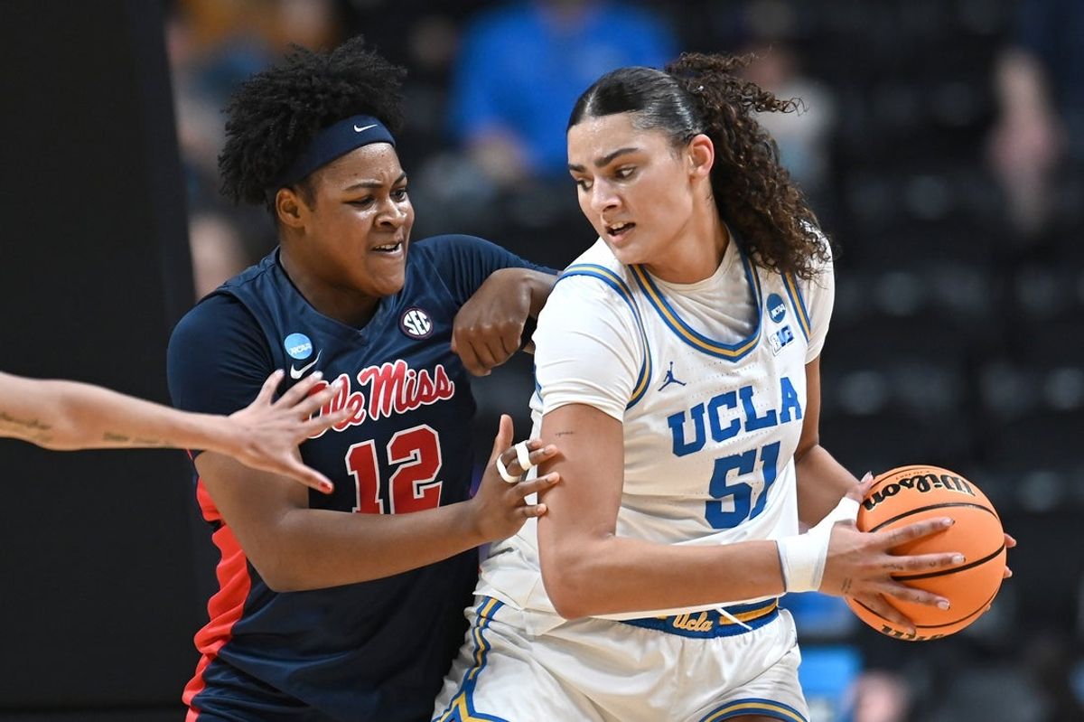 Mar 28, 2025; Spokane, WA, USA; UCLA Bruins center Lauren Betts (51) fights for position against Ole Miss Rebels forward Christeen Iwuala (12). during the first half of a Sweet 16 NCAA Tournament basketball game at Spokane Arena. at Spokane Arena. Mandatory Credit: James Snook-Imagn Images