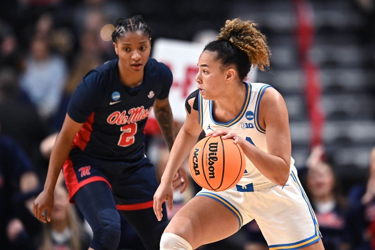 Mar 28, 2025; Spokane, WA, USA; UCLA Bruins guard Kiki Rice (1) controls the ball against Ole Miss Rebels guard Tameiya Sadler (2) during the first half of a Sweet 16 NCAA Tournament basketball game at Spokane Arena. at Spokane Arena. Mandatory Credit: James Snook-Imagn Images