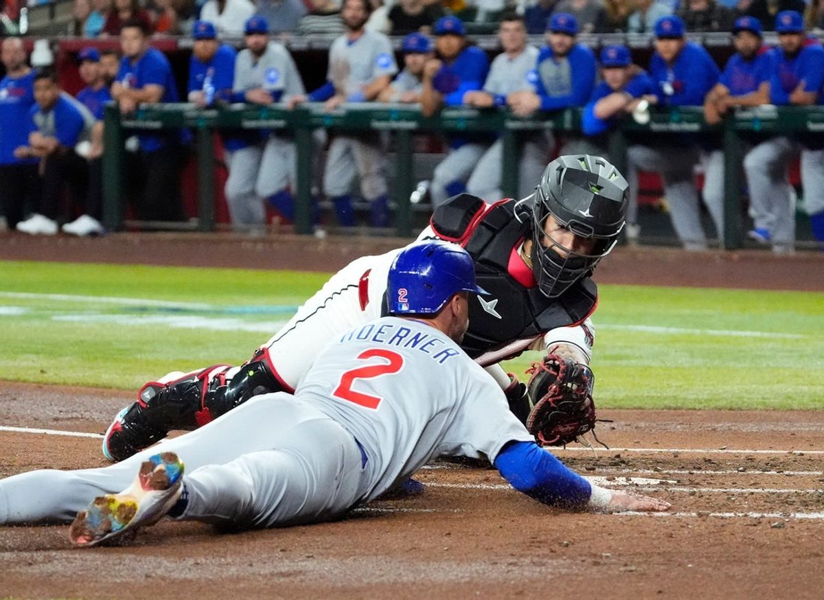 Arizona Diamondbacks catcher Jose Herrera tags-out Chicago Cubs Nico Hoerner at home plate in the second inning at Chase Field in Phoenix, on March 28, 2025.