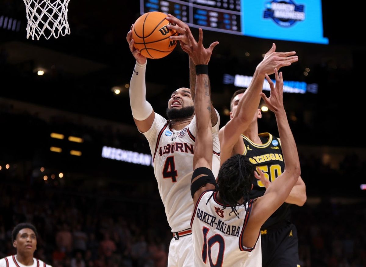 Mar 28, 2025; Atlanta, GA, USA; Auburn Tigers forward Johni Broome (4) rebounds against Michigan Wolverines center Vladislav Goldin (50) in the second half of a South Regional semifinal of the 2025 NCAA tournament at State Farm Arena. Mandatory Credit: Brett Davis-Imagn Images
