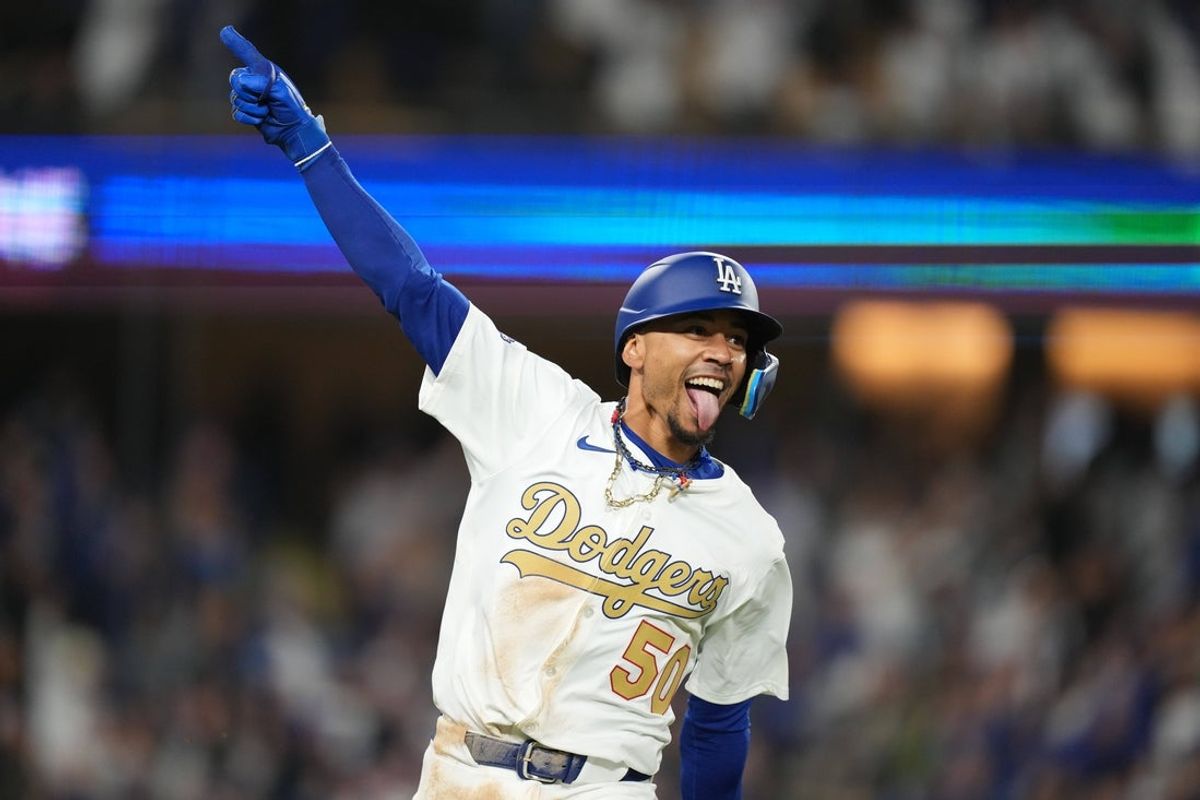 Mar 28, 2025; Los Angeles, California, USA;  Los Angeles Dodgers shortstop Mookie Betts (50) hits a 3 run home run during the tenth inning against the Detroit Tigers at Dodger Stadium. Mandatory Credit: Kirby Lee-Imagn Images