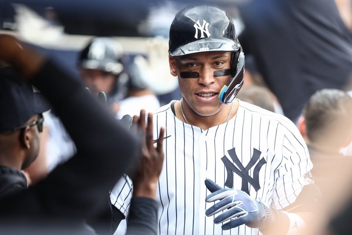 Mar 29, 2025; Bronx, New York, USA; New York Yankees right fielder Aaron Judge (99) is greeted in the dugout after hitting a two run home in the fourth inning against the Milwaukee Brewers at Yankee Stadium. Mandatory Credit: Wendell Cruz-Imagn Images