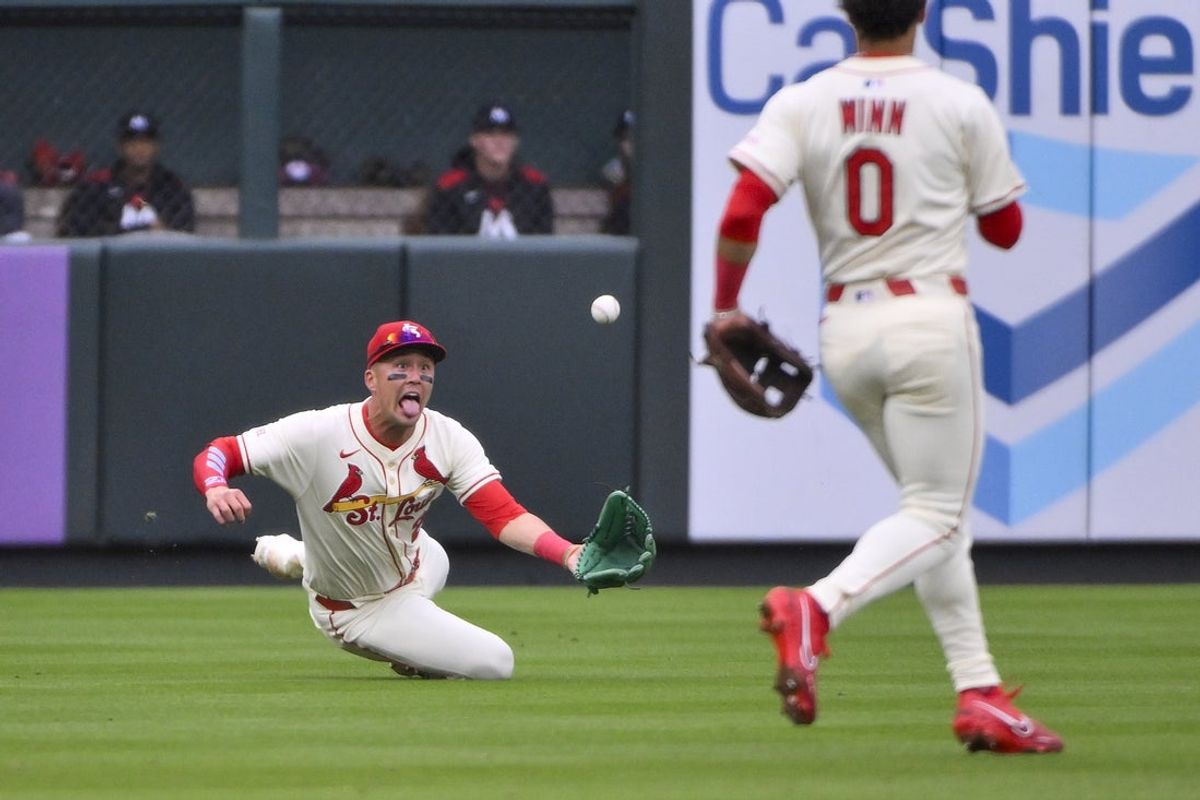 Mar 29, 2025; St. Louis, Missouri, USA;  St. Louis Cardinals left fielder Lars Nootbaar (21) dives and catches a line drive hit by Minnesota Twins third baseman Jose Miranda (not pictured) during the second inning at Busch Stadium. Mandatory Credit: Jeff Curry-Imagn Images
