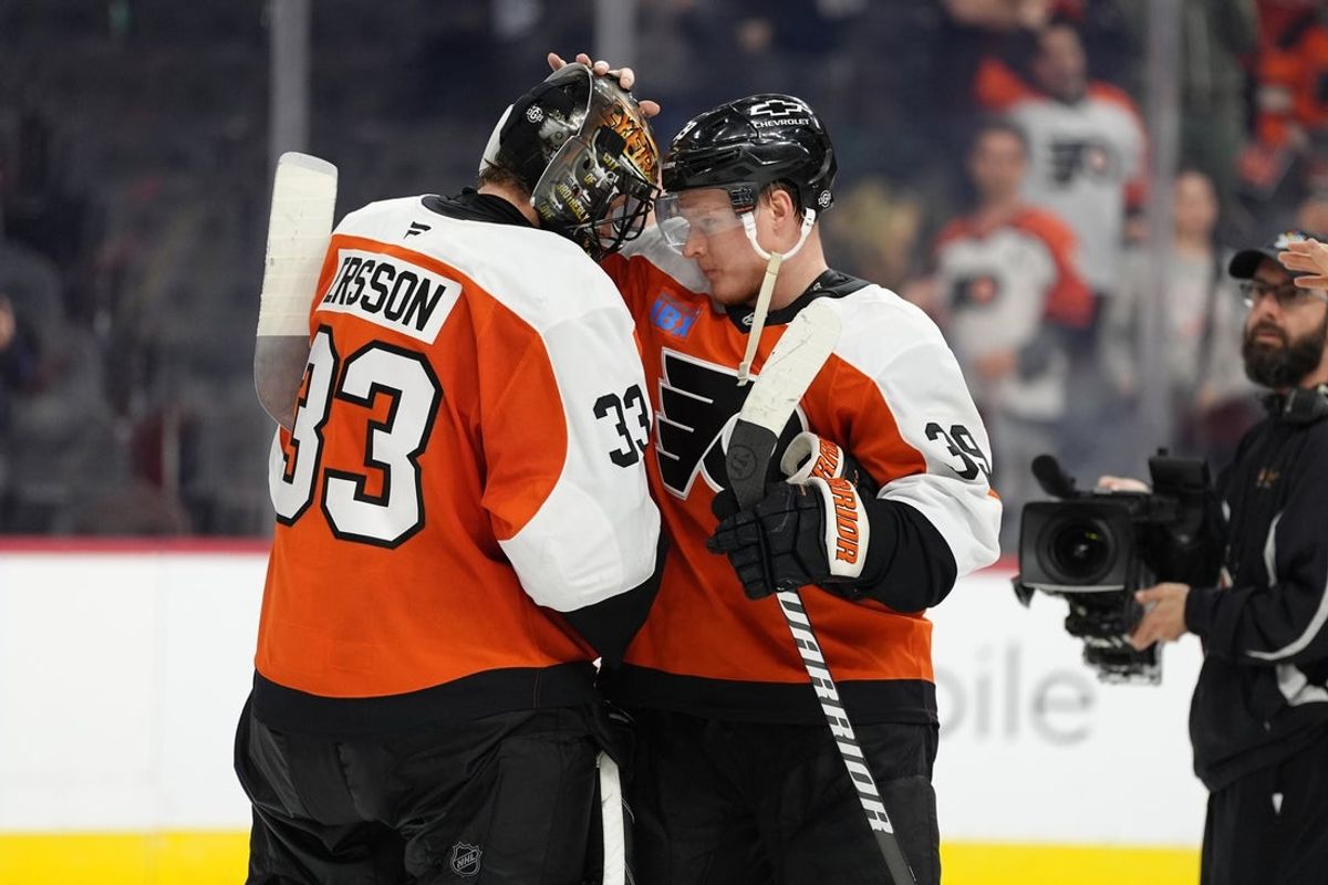 Mar 29, 2025; Philadelphia, Pennsylvania, USA; Philadelphia Flyers right wing Matvei Michkov (39) reacts with goalie Samuel Ersson (33) after the game against the Buffalo Sabres at Wells Fargo Center. Mandatory Credit: Kyle Ross-Imagn Images
