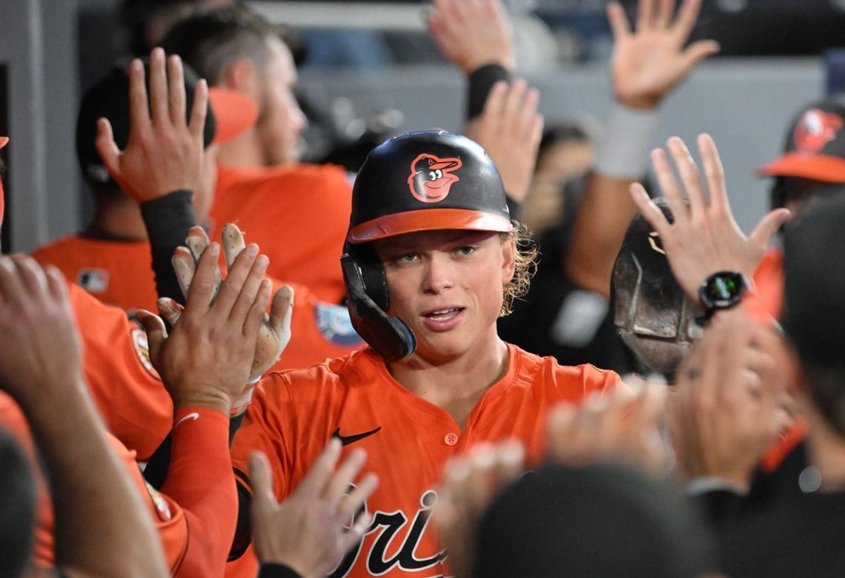 Mar 29, 2025; Toronto, Ontario, CAN; Baltimore Orioles shortstop Jackson Holliday (7) celebrates with team mates in the dugout after scoring against the Toronto Blue Jays in the fourth inning at Rogers Centre. Mandatory Credit: Dan Hamilton-Imagn Images