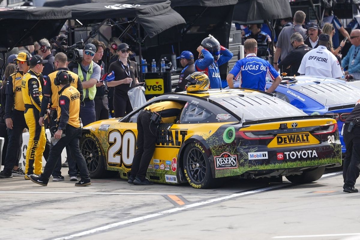 Mar 29, 2025; Martinsville, Virginia, USA; NASCAR Cup Series driver Christopher Bell (20) and his crew wait to be announced to be the pole sitter during practice and qualifying for the Cook Out 400 at Martinsville Speedway. Mandatory Credit: Jim Dedmon-Imagn Images